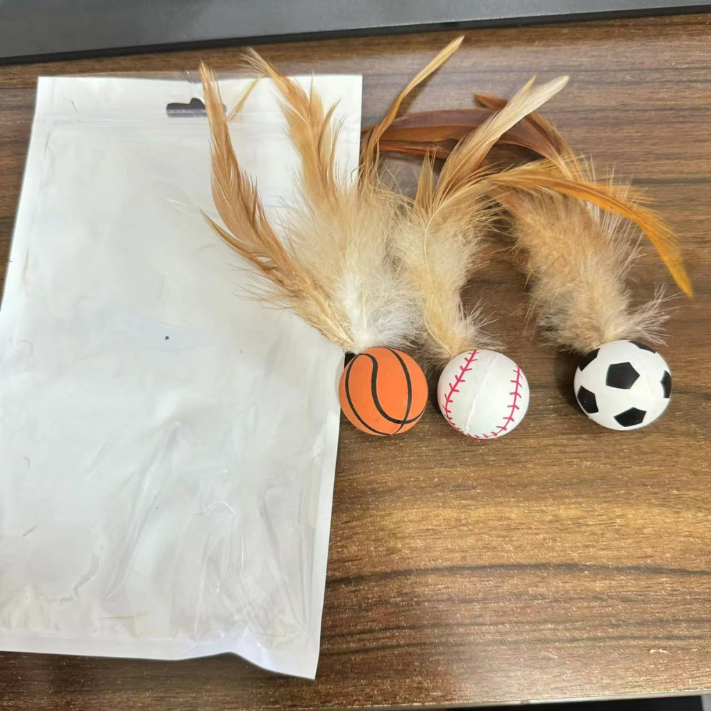 Rubber feather bouncy cat toy on a hard floor