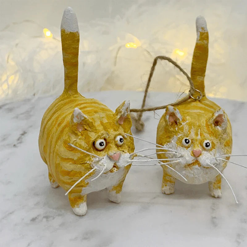 Tortoiseshell cat Christmas ornament hanging on a tree
