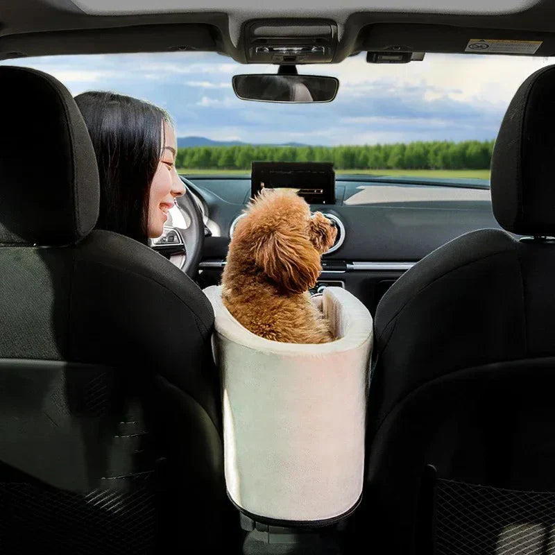 Small dog resting in the DogHaven travel bed between car seats