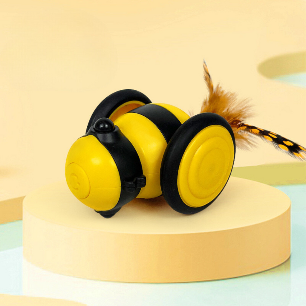 Cat playing with the interactive bee toy