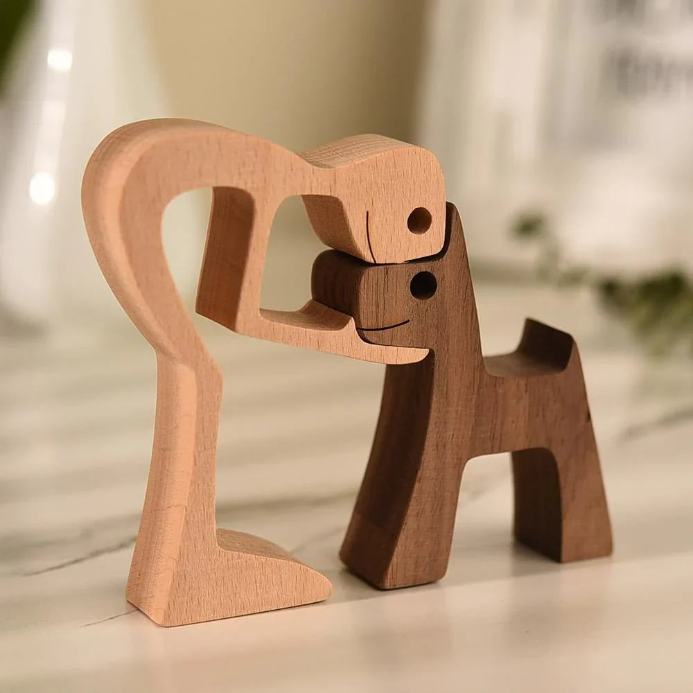 Hand-carved wooden figurine of a person and dog