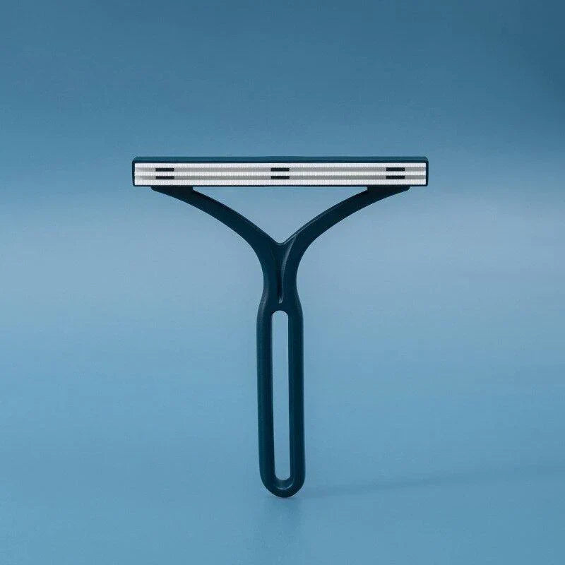 CleanSwipe brush lifting pet hair from a fabric sofa