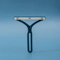 CleanSwipe brush lifting pet hair from a fabric sofa