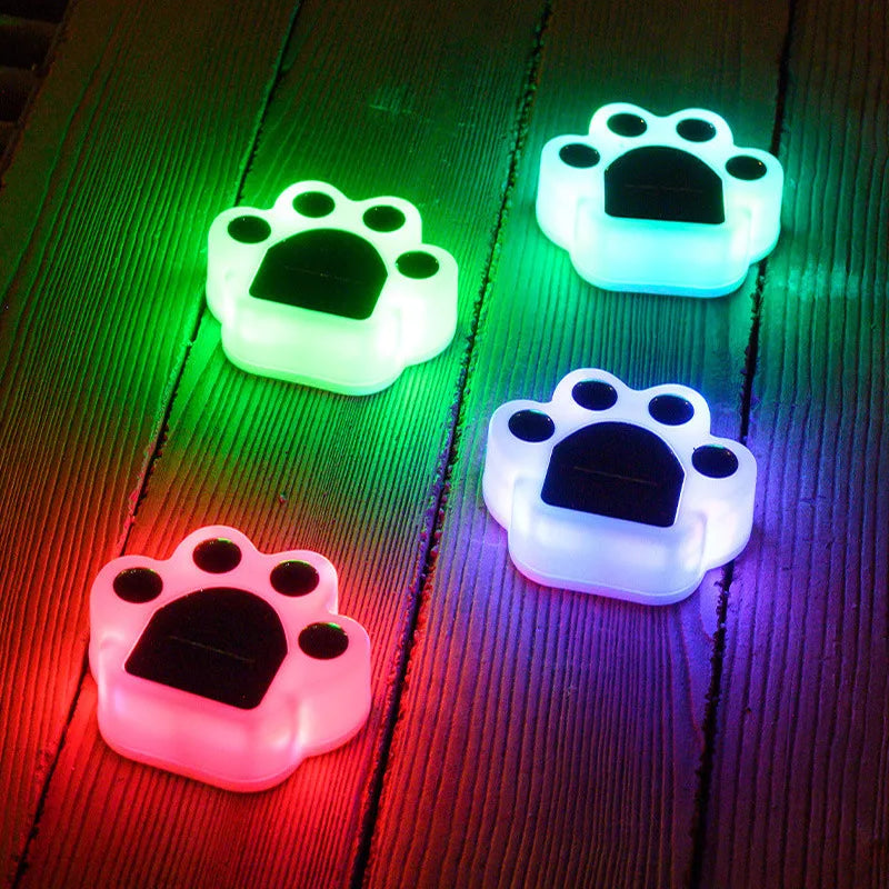 PawsLumen garden light staked into a garden bed