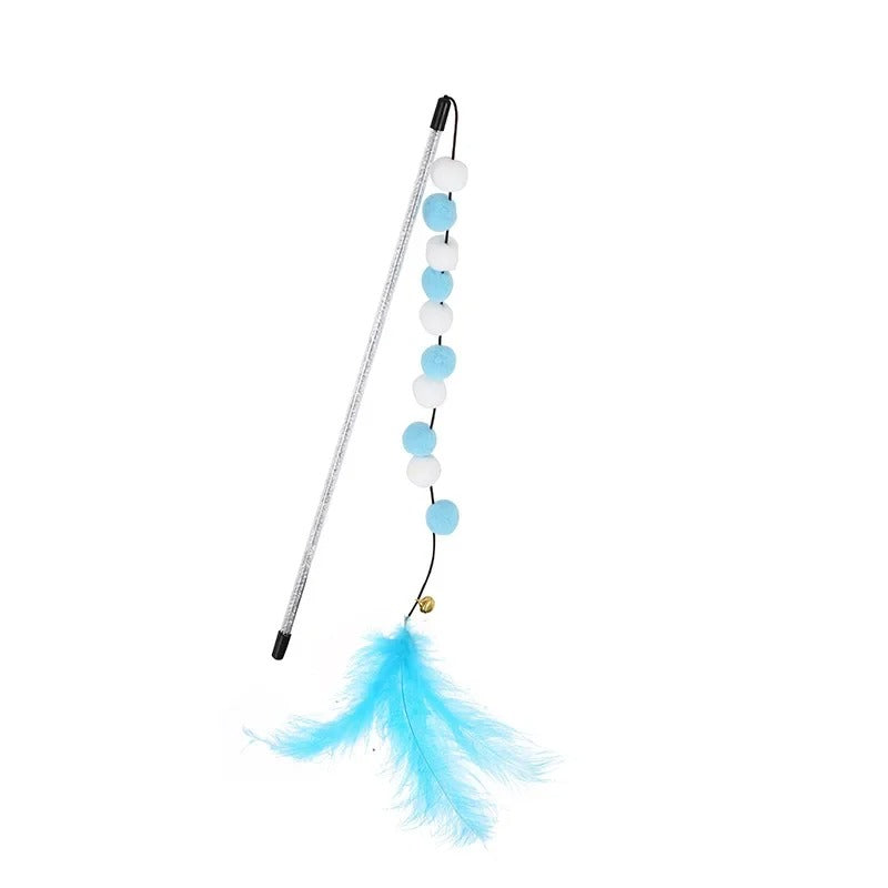 Cat leaping at the feather teaser wand