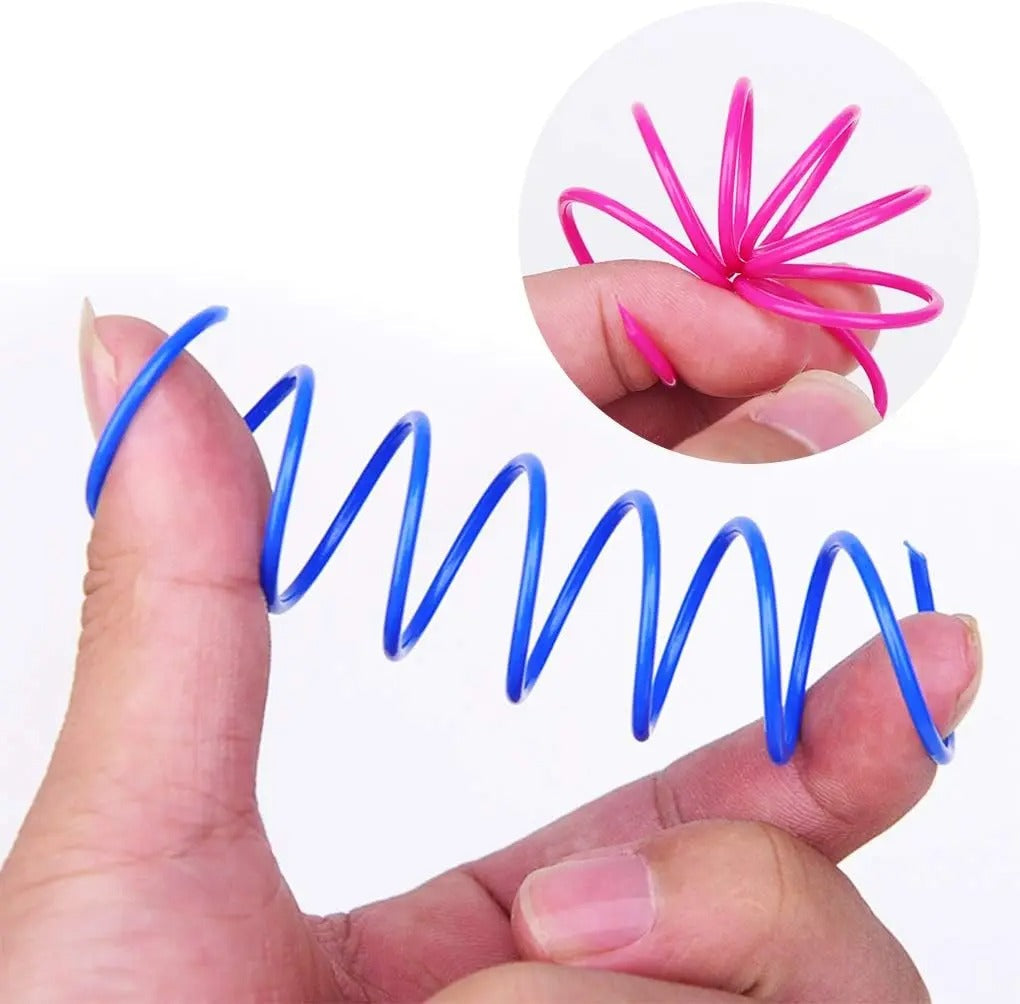 Cat batting a colourful spiral spring toy