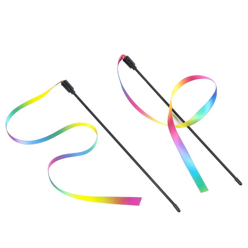 Cat playing with the rainbow ribbon wand