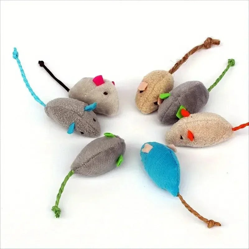 Cat pouncing on a plush rat toy