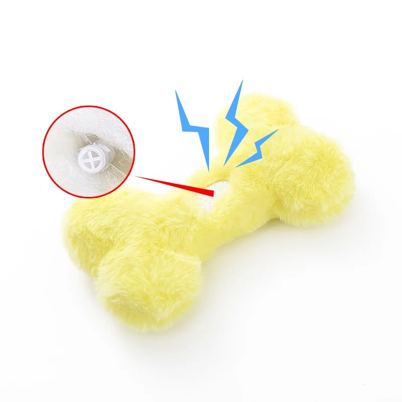 Dog cuddling the Love Bone plush toy