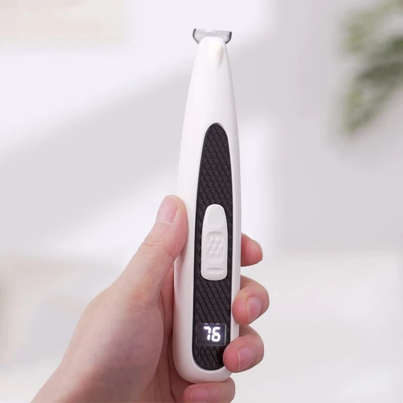 Pet paw trimmer held in hand for grooming
