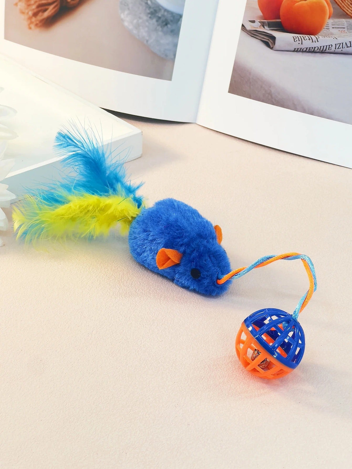 Plush mouse toy with string and bell laid out