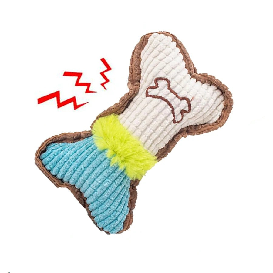 Small dog chewing the plush bone toy